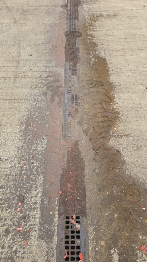 Wet concrete with tire tracks
