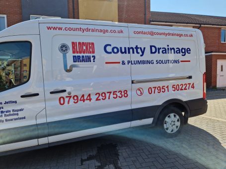 White van for County Drainage & Plumbing Solutions with contact numbers and website details.